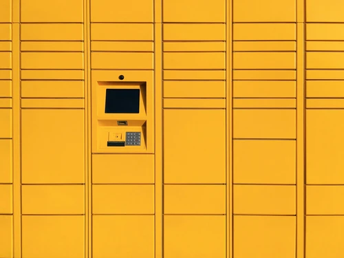 a yellow wall with a pay phone in it