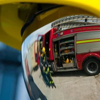 A fireman in a helmet with reflective visor down