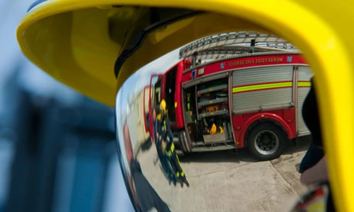 A fireman in a helmet with reflective visor down