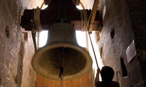 Bell ringer playing  in the tower bell next to the cathedral of Valencia, Spain