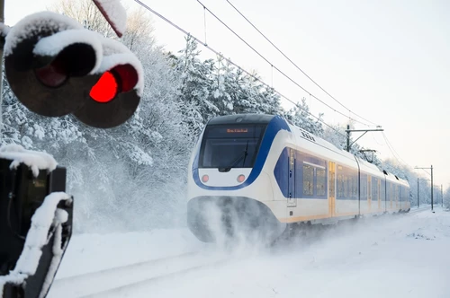 Dutch,Yellow,And,Blue,Train,Riding,In,The,Snow