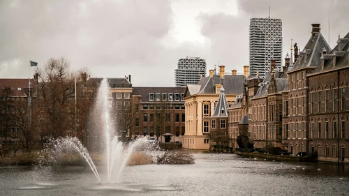 water fountain in the middle of city buildings during daytime