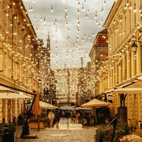 A city street filled with lots of tables and umbrellas