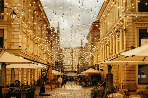 A city street filled with lots of tables and umbrellas