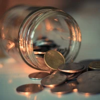 clear glass jar with coins