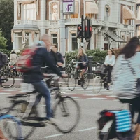 people riding bicycle on road during daytime