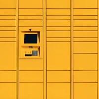 a yellow wall with a pay phone in it