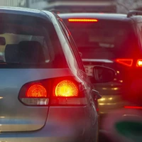 a group of cars driving down a street next to each other