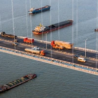 Bridges with trucks and cargo ships.