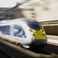 A low shutter speed shot of a Eurostar E320 passing through Stratford International at high speed.