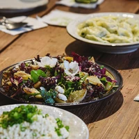 a wooden table topped with plates of food