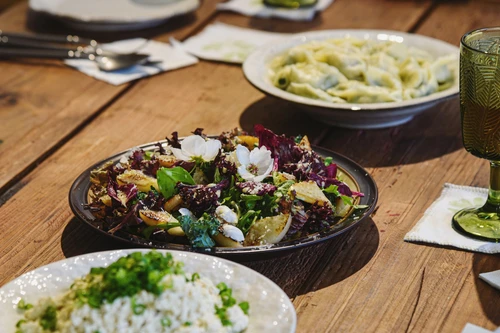 a wooden table topped with plates of food