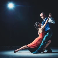 couple dancing dramatically under the spotlight