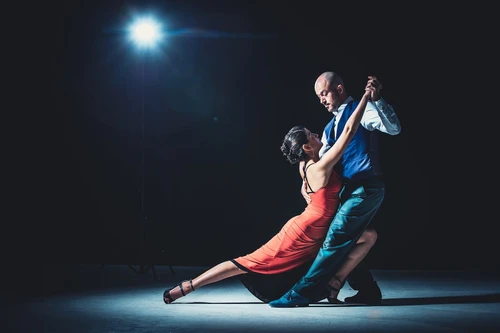couple dancing dramatically under the spotlight