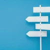 white sign with four arrows pointing different directions sign is blue background sign is meant represent idea direction guidance 1086261 10861