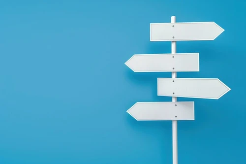 white sign with four arrows pointing different directions sign is blue background sign is meant represent idea direction guidance 1086261 10861