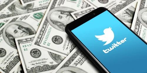 Twitter,Logo,On,Smartphone,Screen,On,Background,Of,Dollars.,Twitter