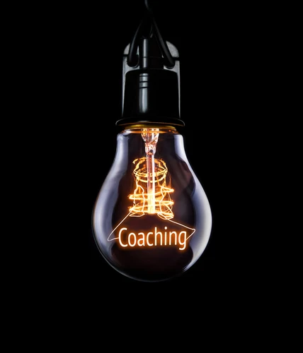 Hanging,Lightbulb,With,Glowing,Coaching,Concept.